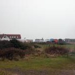 Beach cafe and beach huts, seen from the land side, Hayling Island.