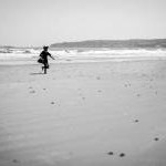 Boy on the beach - Portmarnock, Ireland - Black and white street photography