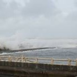 Waves breaking over the old Lido, Longsands Beach